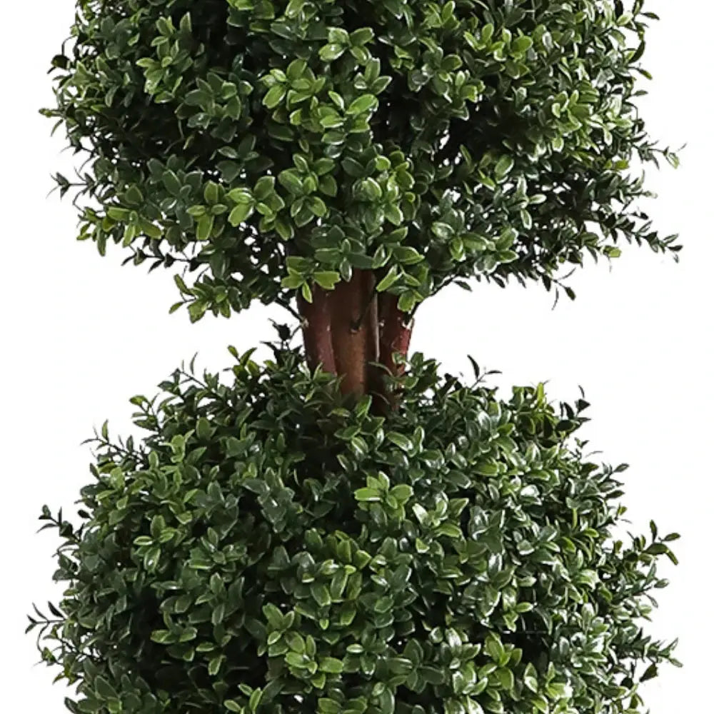 close up of triple ball boxwood topiary showing three rounded green spheres stacked vertically from base to top