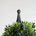 detailed view of artificial dark green boxwood leaves showing rich evergreen color and small round glossy texture