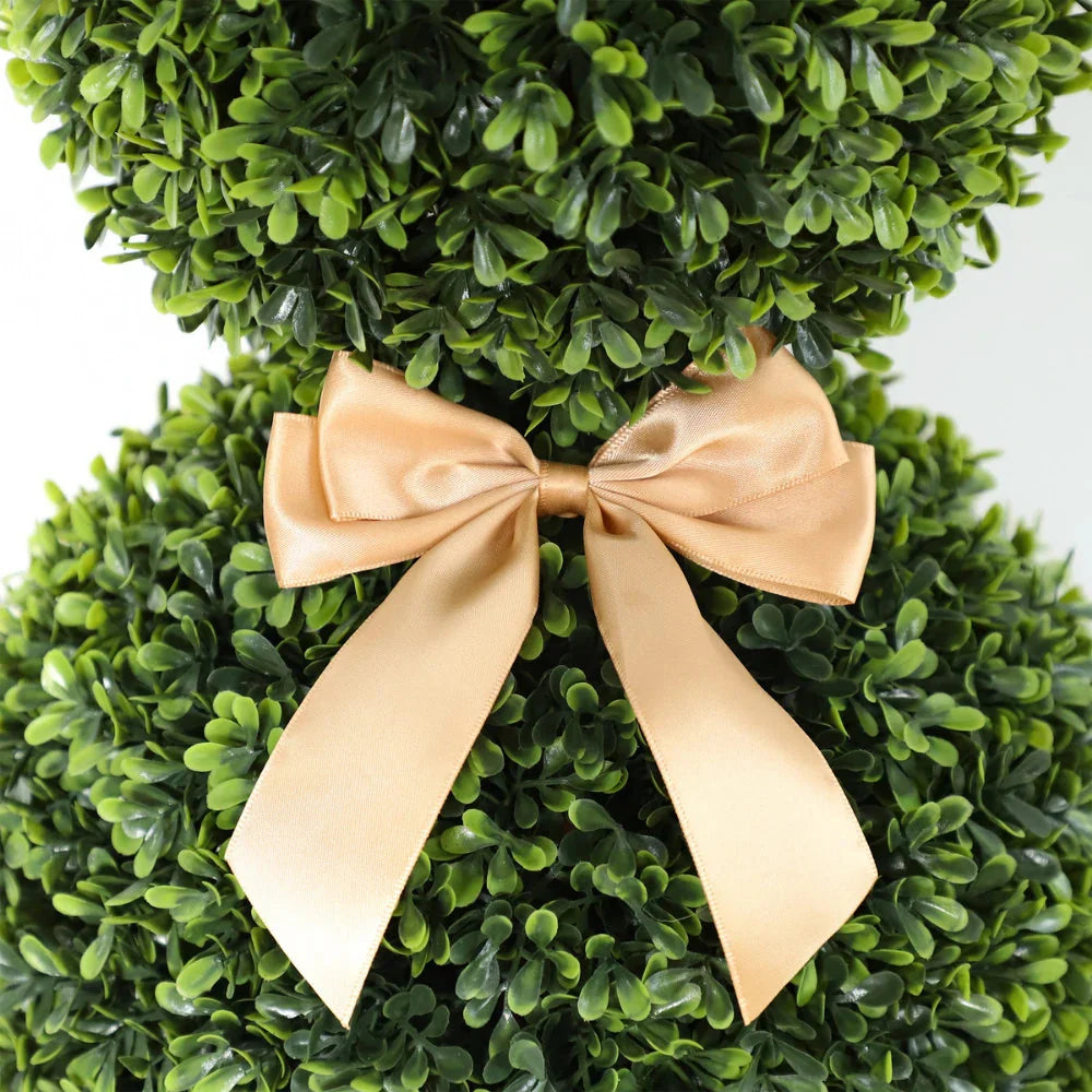 close up of artificial bunny topiary head showing leaf covered round face with button eyes and floppy ears