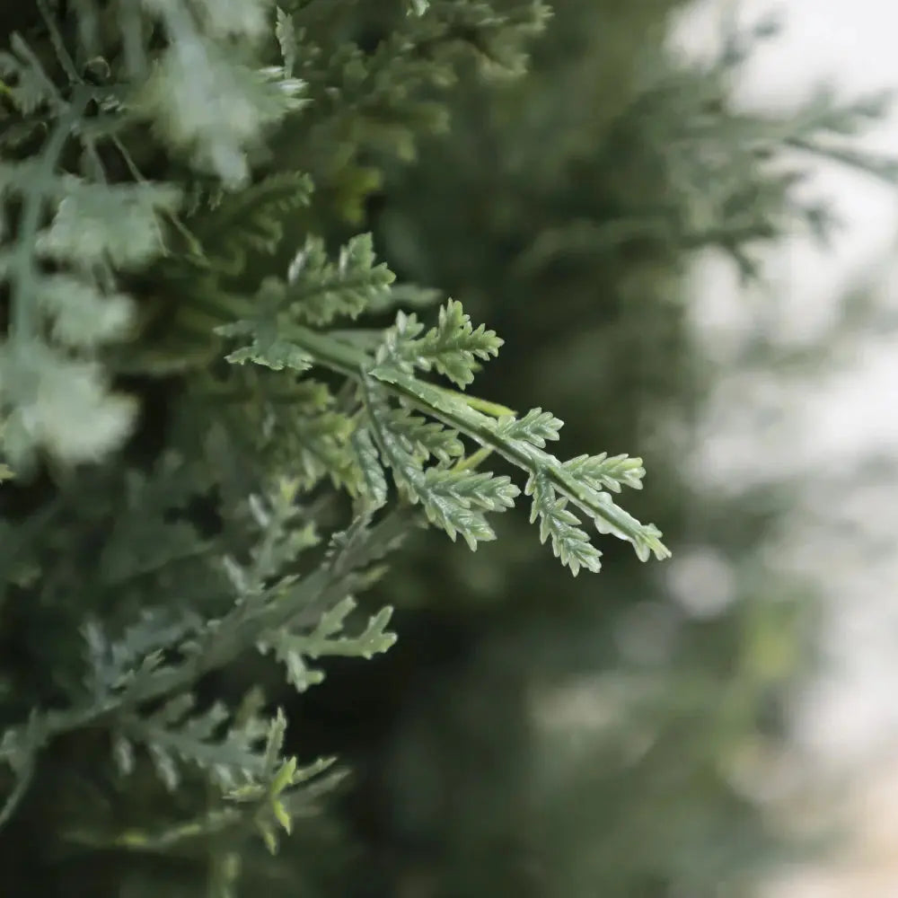 detailed view of artificial cedar foliage on 49 inch tree showing soft green needle like leaves with natural texture