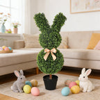 two easter bunny topiaries on fireplace mantel or console table for indoor holiday decor with pastel accents