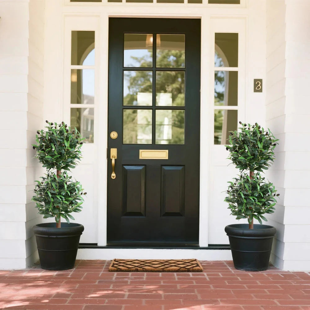 detailed view of artificial olive topiary leaves showing silvery green color, small oval shape, and natural matte finish
