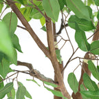 tall artificial ficus tree in modern office open area adding greenery and privacy screen between workstations