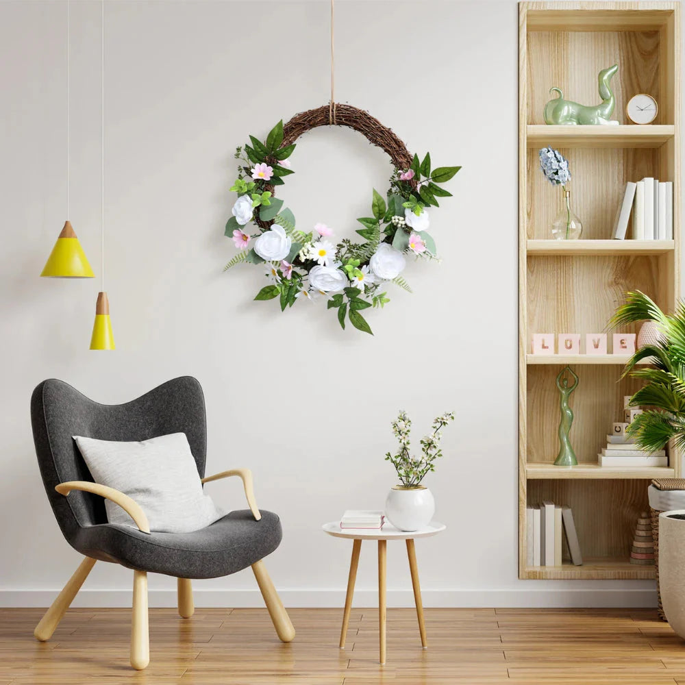 natural twig base of faux wreath with intertwined branches and attached white rose clusters for rustic elegant look