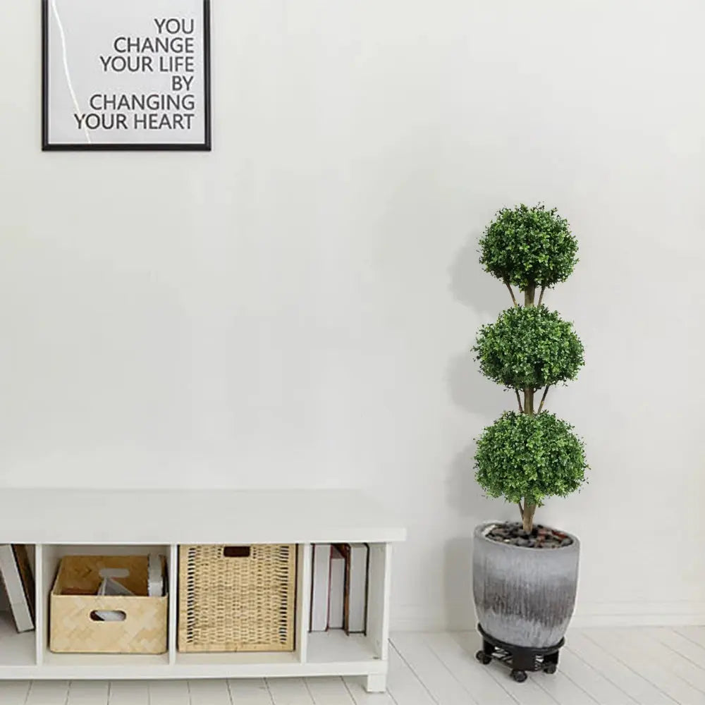 triple ball boxwood topiary on each side of fireplace mantel for balanced formal living room