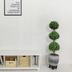 triple ball boxwood topiary on each side of fireplace mantel for balanced formal living room
