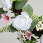 artificial white rose wreath used as wedding ceremony decor on wooden arch with draping fabric and aisle