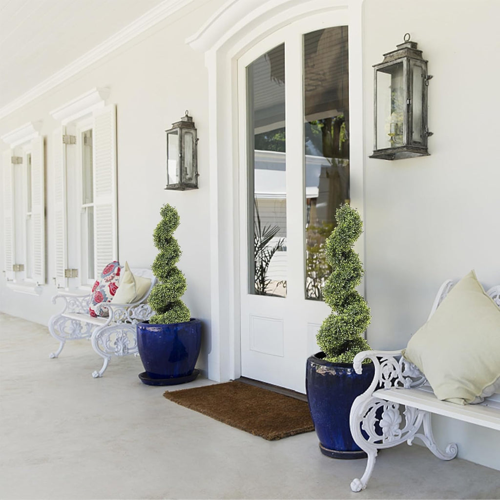 set of 2 compact spiral topiary trees flanking front entrance door for elegant welcome in smaller scale