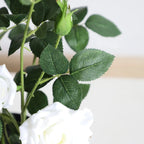 detailed view of artificial rose leaves showing glossy green color, serrated edges, and natural vein patterns