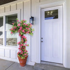 tall faux flowering tree at grand front entrance door or double door entry for dramatic tropical welcome
