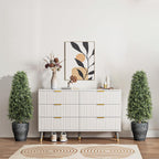 two boxwood pyramid topiaries on each side of fireplace mantel for balanced formal living room