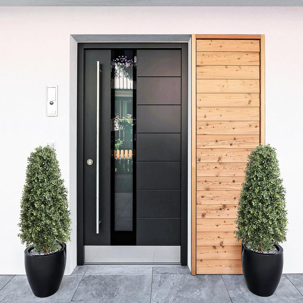 pair of 3 foot boxwood pyramid topiaries flanking front entrance door for classic formal welcome