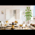 large artificial olive tree in modern hotel lobby reception area with marble flooring and neutral decor