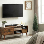 two tall faux cedar topiary trees on each side of fireplace mantel adding year round greenery to living room