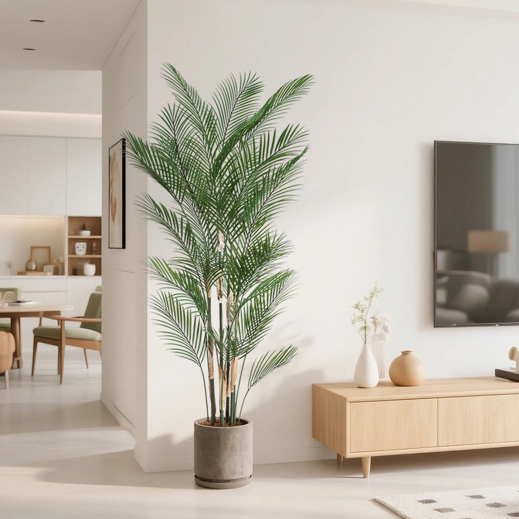 71 inch tall faux palm tree next to standing person for scale demonstrating nearly 6 foot height