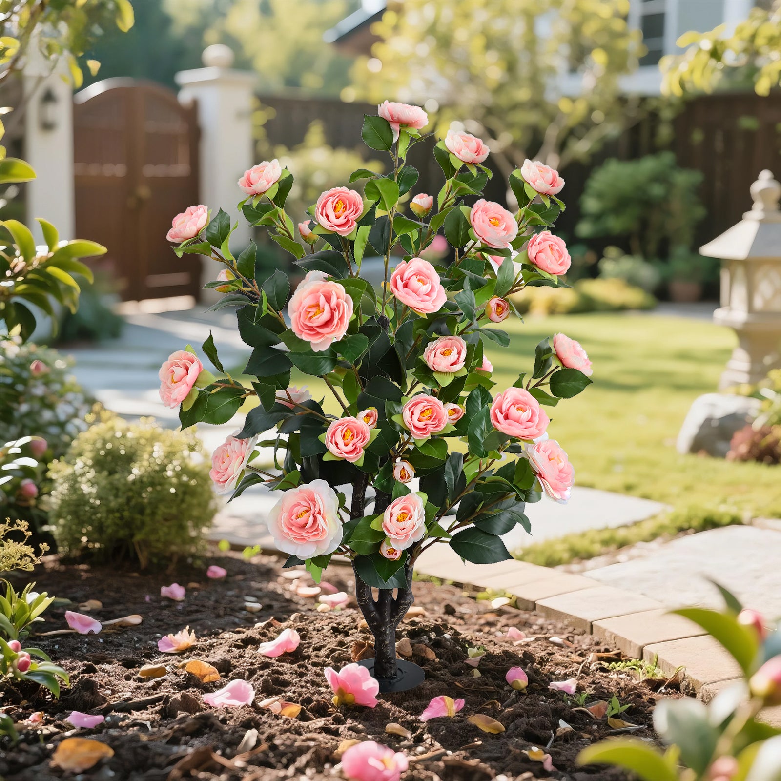 realistic pink camellia flower and leaves close up
