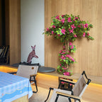 63 inch faux flowering tree in living room corner with high ceiling adding vibrant color and vertical presence