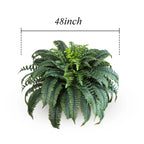 artificial boston fern in macrame hanging basket suspended from ceiling showing full trailing length